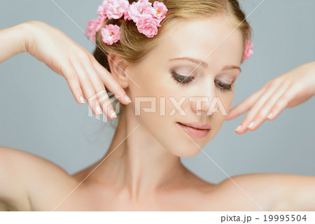 Beauty face of young beautiful woman with pink flowers Beauty face of young beautiful woman with pink flowers 19995504