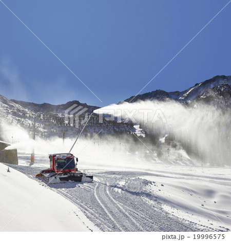 Red snow groomer and snow canon in the mountain 19996575