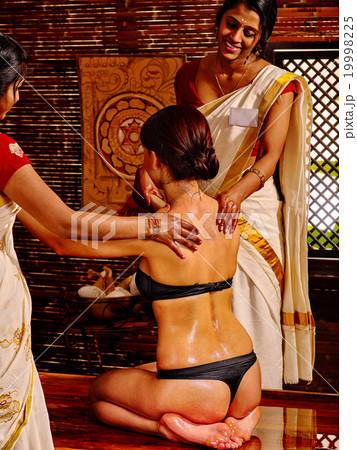 Woman luxuriate  at Ayurvedic spa treatment. 19998225