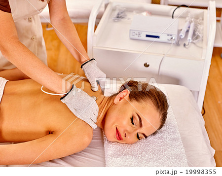 Woman receiving electricity gloves massage at 19998355