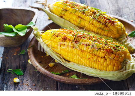Steamed corn whith ingredient herb on wooden plate Steamed corn whith ingredient herb on wooden plate 19999912