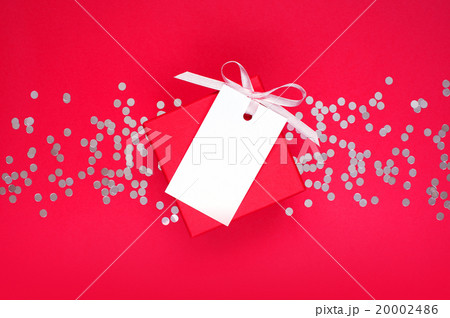 Gift box and empty tag with ribbon on the red Gift box and empty tag with ribbon on the red 20002486