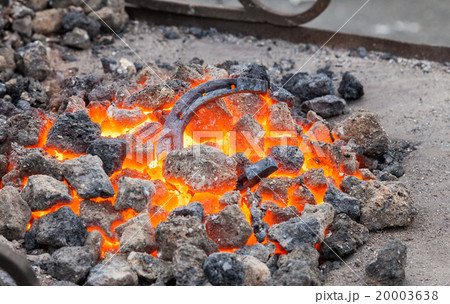 Blacksmithing, horseshoe is heated in the forge 20003638