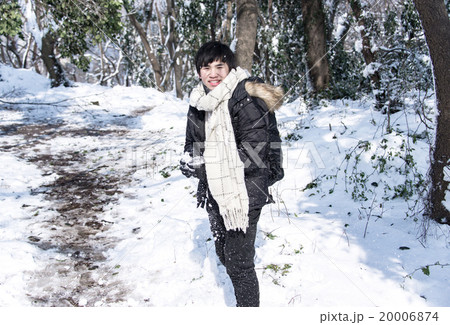 Outdoor portrait of man in down coat playing snow Outdoor portrait of man in down coat playing snow 20006874