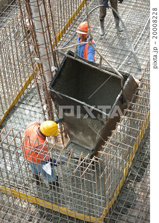 Construction workers casting ground floor slab 20008228