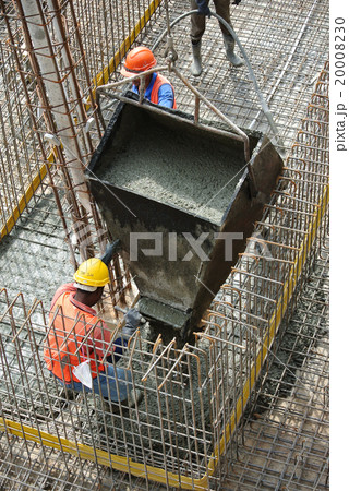 Construction workers casting ground floor slab 20008230