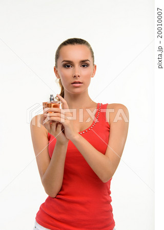Sensual young woman holding perfume bottle. Sensual young woman holding perfume bottle. 20010007