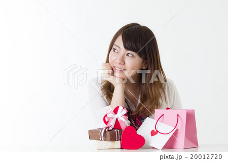 たくさんのプレゼントを前に悩んで頬杖をつく女子高校生 喜ぶプレゼント選び たくさんのプレゼントを前に悩んで頬杖をつく女子高校生 喜ぶプレゼント選び 20012720