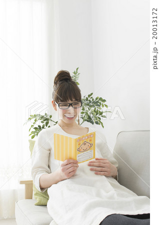 母子手帳を見る妊婦 20013172