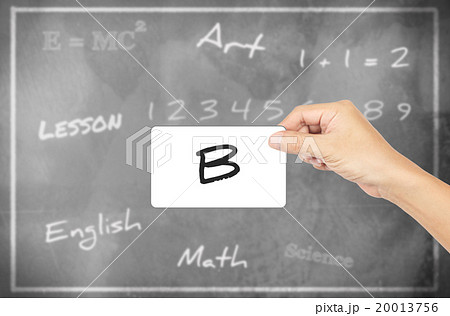 Hand holding card with word of "B" chalkboard background 20013756