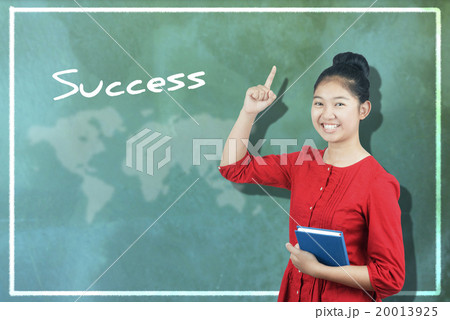The word "Success" and cute Asian girl against chalkboard 20013925