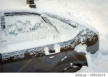 Snow covered car after snowfall 20019214