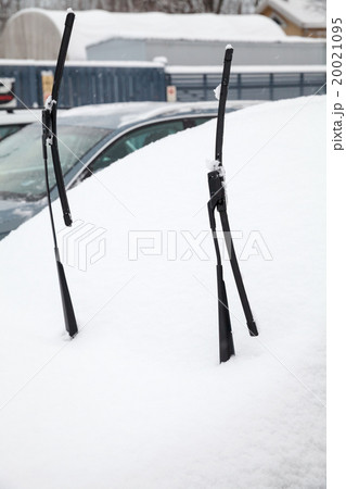 Car wipers lifted up over car covered with snow 20021095
