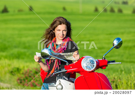 Young woman traveling by a scooter Young woman traveling by a scooter 20028097
