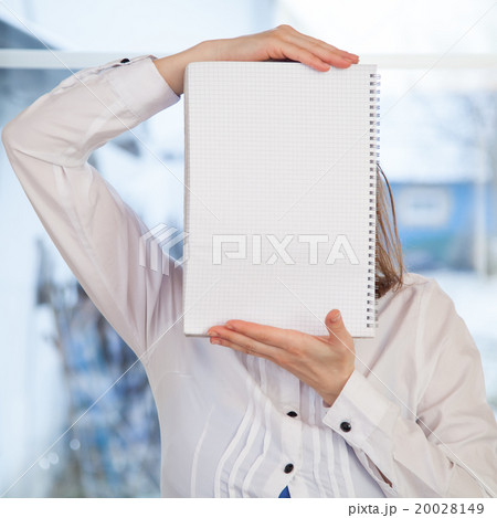 Woman holding blank ring-bound notebook Woman holding blank ring-bound notebook 20028149