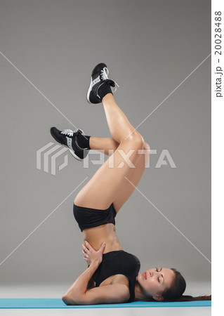 Beautiful sporty girl standing in acrobat pose or 20028488