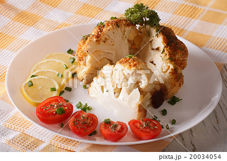 cut cauliflower baked close-up on a plate 20034054