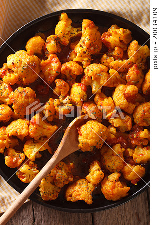 cauliflower in curry sauce on a plate close-up cauliflower in curry sauce on a plate close-up 20034109