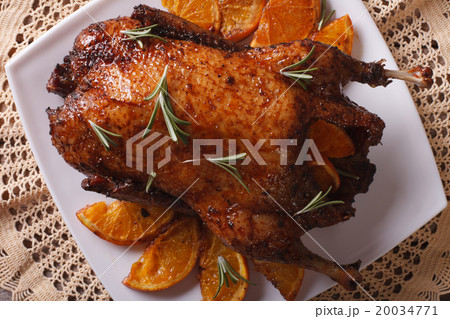 Roast duck with oranges close up on a plate Roast duck with oranges close up on a plate 20034771