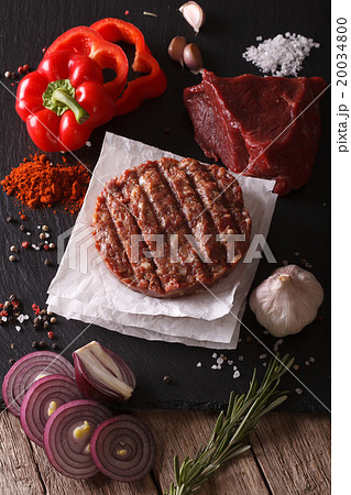 Raw burgers cutlets close-up with the ingredients 20034800