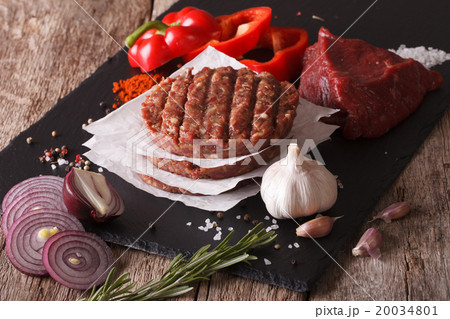 Raw burgers cutlets close-up with the ingredients Raw burgers cutlets close-up with the ingredients 20034801