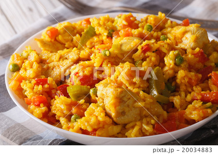 Rice with chicken and vegetables in a bowl macro 20034883