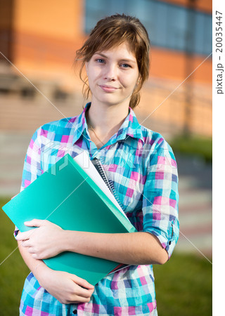 Portrait of young alluring woman holding education 20035447