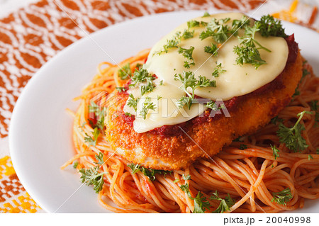 Chicken Parmigiana and pasta close-up on a plate 20040998