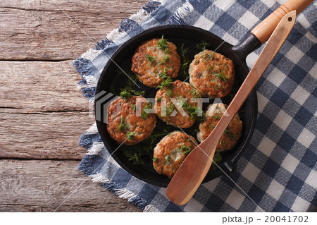 fish cakes with herbs in a frying pan 20041702