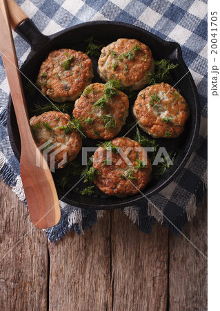 fish cakes with herbs close-up in a pan fish cakes with herbs close-up in a pan 20041705