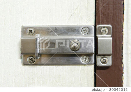 Padlock on weathered white door 20042012