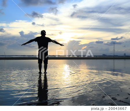 man feel free on a foggy beach with reflection 20043667