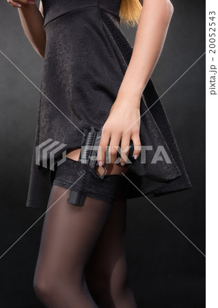 girl hand with a gun on a dark background in girl hand with a gun on a dark background in 20052543