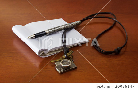 Blank note book with pen on wood table Blank note book with pen on wood table 20056147