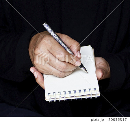 Businesswoman takes notes in office Businesswoman takes notes in office 20056317