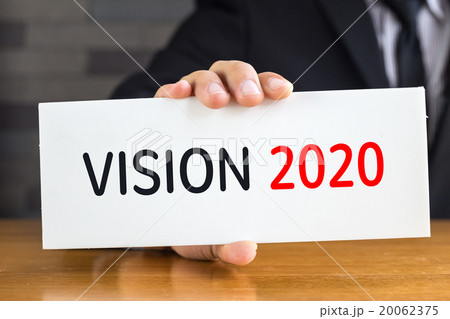 Vision 2020, message on white card by businessman 20062375
