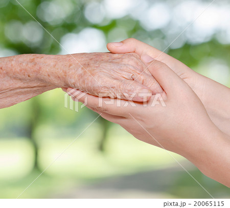 Young woman holding her grandmother hand Young woman holding her grandmother hand 20065115