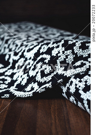 black textile with beautiful white ornament on 20072233