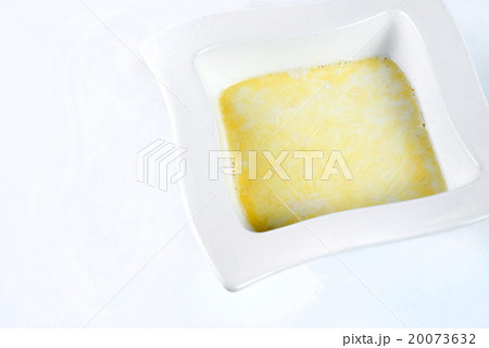 semolina porridge with melted butter on white 20073632