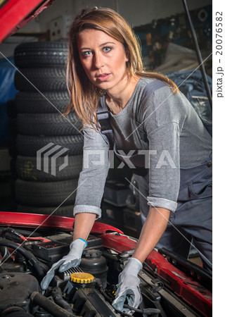 Female car mechanic in auto repair service Female car mechanic in auto repair service 20076582
