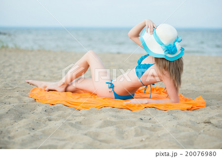 Young lady sunbathing on a beach. Beautiful woman Young lady sunbathing on a beach. Beautiful woman 20076980