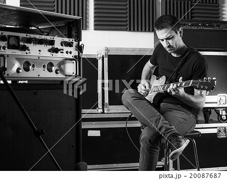 Guitarist playing backstage Guitarist playing backstage 20087687