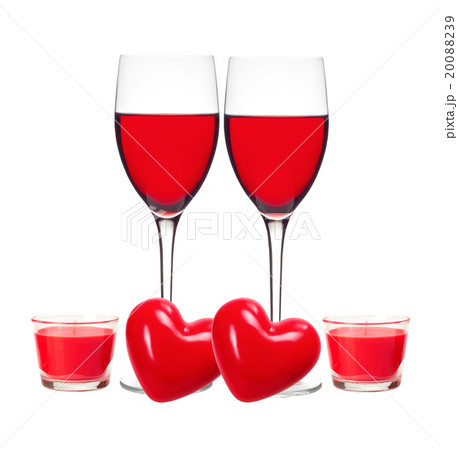 Glass of Red Wine, red hearts and candles isolated 20088239