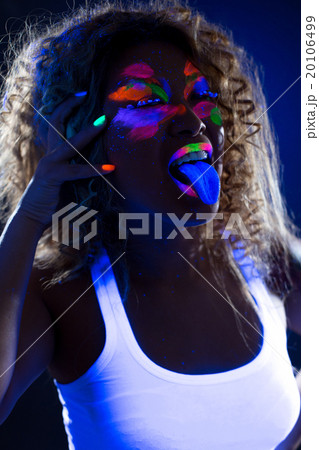 Image of funny girl posing at camera in UV light 20106499