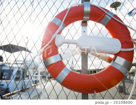 lifebuoy over moored boats on pier 20108600