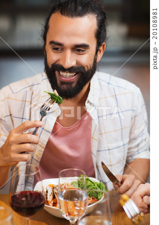 happy man having dinner at restaurant happy man having dinner at restaurant 20108981