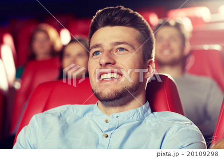 happy young man watching movie in theater 20109298