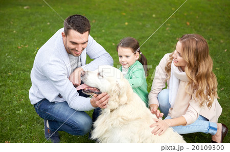 happy family with labrador retriever dog in park 20109300