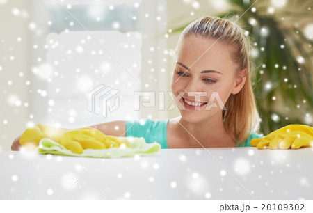 happy woman cleaning table at home kitchen 20109302