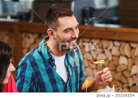 happy man having dinner at restaurant 20109304